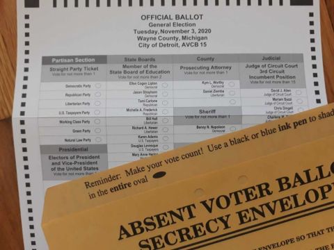 Michigan absentee ballot, next to it is a brown envelope 