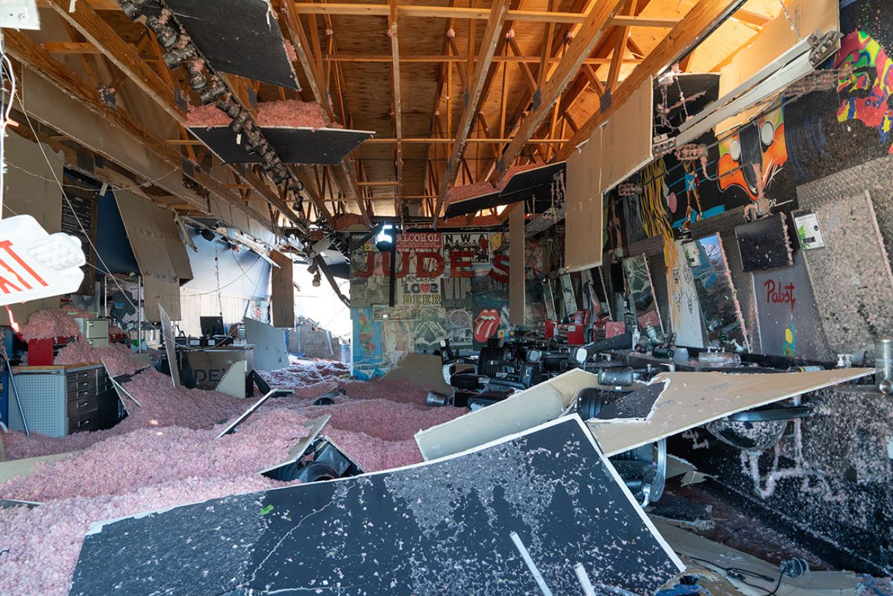 the inside of a Jude's barbershop is damaged
