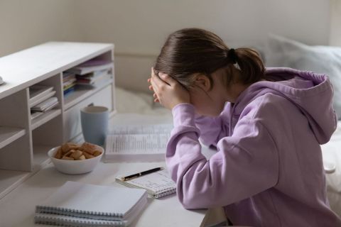 Girl is stressed at desk