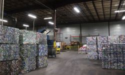  Aluminum cans and bottles are pressed into bricks of recyclable material, waiting to be shipped and formed into new beverage containers