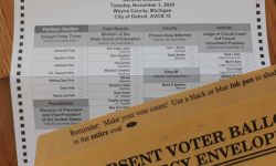 Michigan absentee ballot, next to it is a brown envelope 