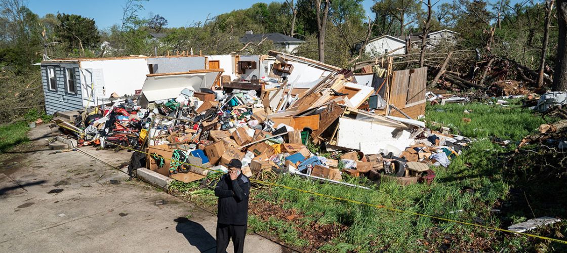 Man standing in front of a destroyed building in Portage, Michigan