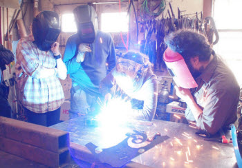 DIY EMPLOYMENT: Welding students practice at the Jackson Academy for Manufacturing Careers, a job-training center started by manufacturers to fill a training gap left by cutbacks in public programs. Welders are in high demand right now and can earn $25 an hour. (courtesy photo/used under Creative Commons license)