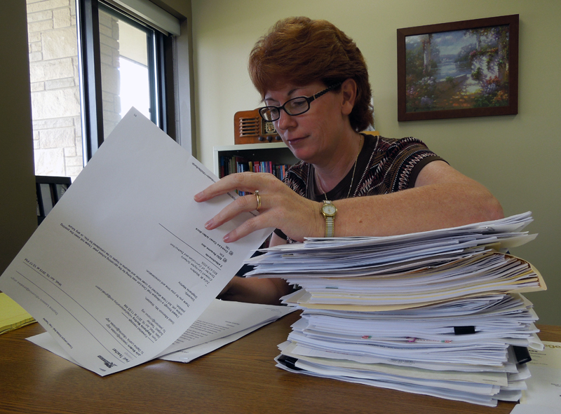 Julie Western looks through a stack of resumes for teacher openings at Croswell-Lexington school district.  (Photo by Ron French) 