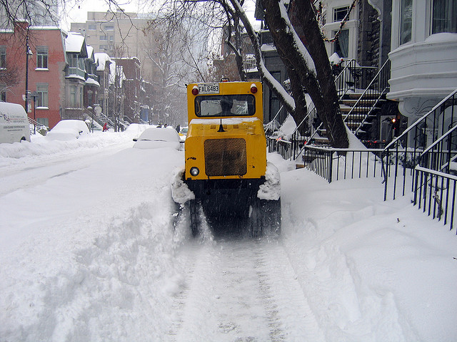 Want a closer neighborhood? Ditch the expensive sidewalk snowplow and clear your own walks. (Photo by Flickr user Simon Law; used under Creative Commons license)