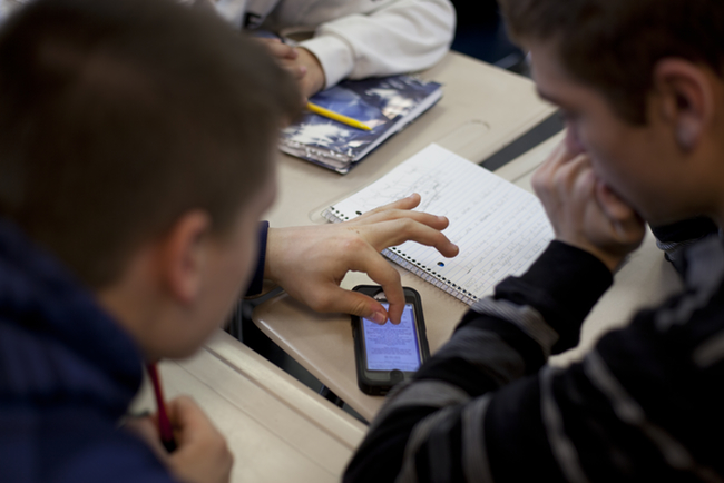 DeWitt Junior High 8th graders use a personal smartphone to work on a project in an algebra class. (Bridge photo by Marcin Szczepanski)