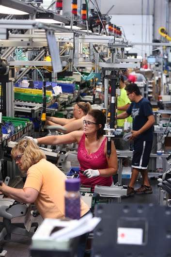 Line workers assemble the Herman Miller Aeron chair at the company's seating factory in Holland. (Photo by Rex Larsen)