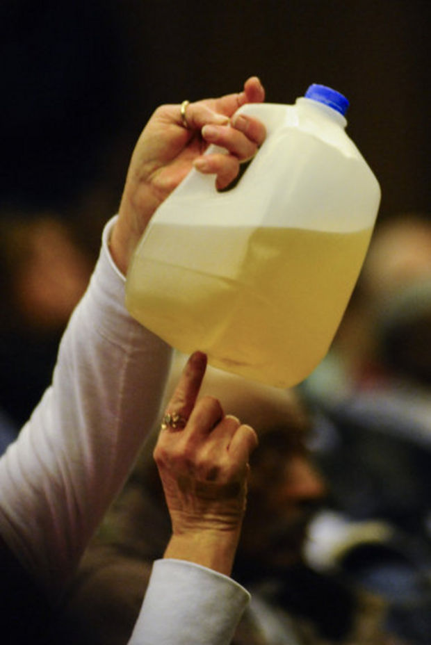 Flint residents are losing patience with officials who say they’ll have to live with the city’s brownish, smelly drinking water until 2016. (photo courtesy of MLive)