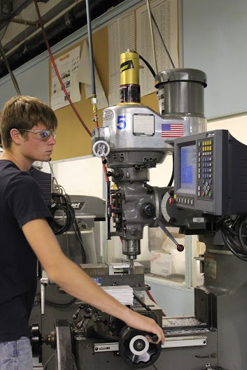 A student at the 175,000-square-foot Jackson Area Career Center operates a precision milling machine, part of a diverse career technical program backed by substantial tax support. (photo credit Jackson Area Career Center) 