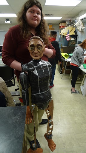 Alex Livengood, a student at Mott Middle College High School, shows off “Adam,” a puppet created in a class at the school. (Photo by Nancy Derringer)