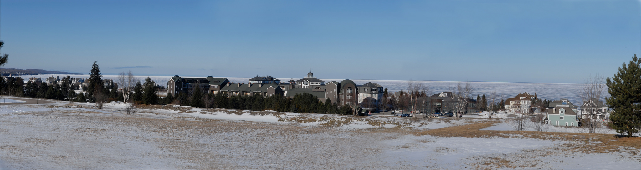 The buildings of Bay Harbor, a luxury mixed-use community, overlook Little Traverse Bay on the site of what was once the Penn-Dixie cement plant. The plant closed in the early ‘80s, and the site was developed years later. (Bridge photo by John Russell)