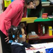 Myka Kirtley, a 5-year-old kindergartner, reads with Dr. Constance Price, principal at Detroit’s Martin Luther King, Jr. Education Center Academy. (Photo by Brian Widdis) 