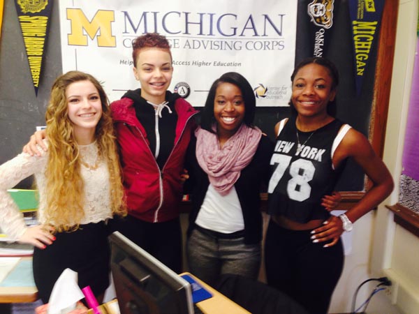 Erin Fischer, third from left, is a Michigan College Advising Corps member assigned full-time at Lansing Eastern High School to try to help students navigate the college application process. Some of the seniors who are heading off to college next fall with the help of the program are, from left, Kayleen Petrovia (headed to Ohio State or the University of South Carolina), India Graham (Pace University) and Cat Hinton (MSU). (Photo by Ron French)