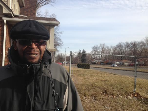 Sherrod Hicks stands along W. Outer Drive, the dividing line between areas that are targeted for multiple demolitions and no immediate demolitions. Hicks is glad to see bulldozers level abandoned homes in his neighborhood. (photo by Bill McGraw)
