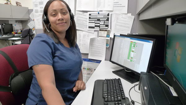 Latrese Williams, a nurse at the John D. Dingell VA Medical Center in Detroit, monitors patients remotely via telemedicine. Her caseload includes hypertension, diabetes and other chronic conditions that can be tracked with devices in patients' homes and delivered to her desktop computer. (Bridge photo by Nancy Derringer)