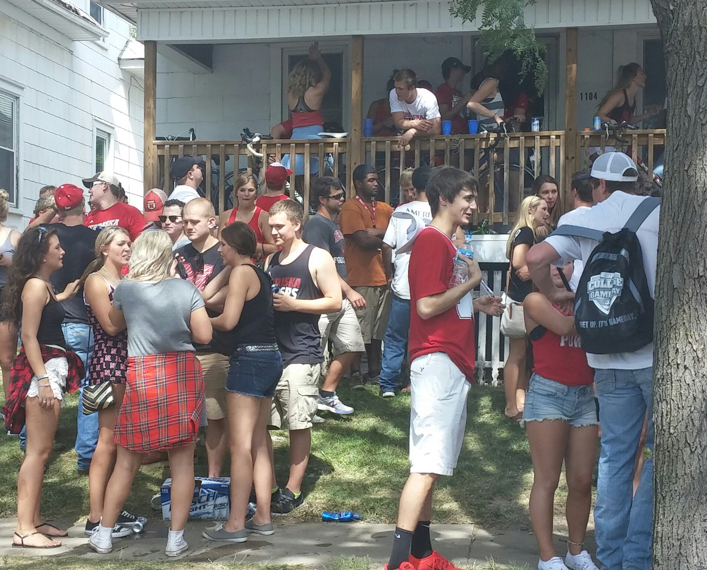 Students party on the lawn and porch of a home in the North Bottoms. Police ultimately shut down this party. (Bridge photo by Mike Wilkinson)