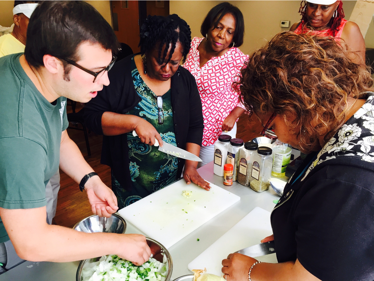 Cooking Matters: Instructor James Hartrick shows participants in a Cooking Matters class in Detroit how to put together a barley jambalaya dish. (Bridge photo by Nancy Derringer)