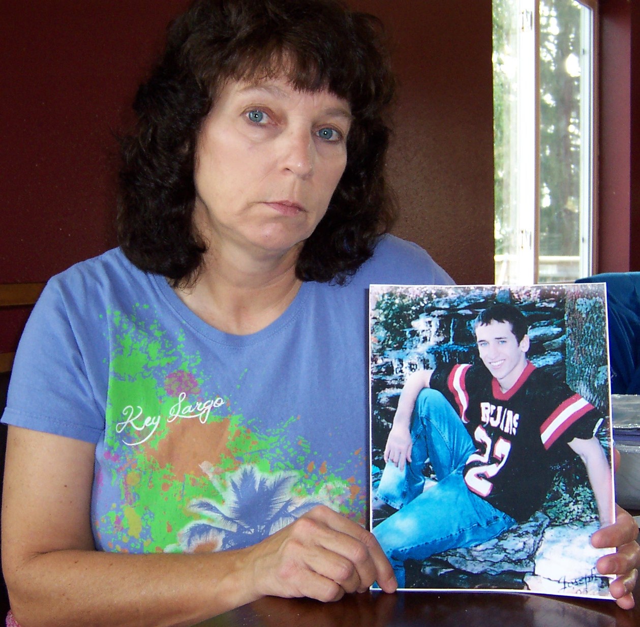 Debra Pyka, holding a picture of her deceased son, Joseph Chernach, says she wants others to know the dangers of tackle football. (Photo courtesy Debra Pyka).