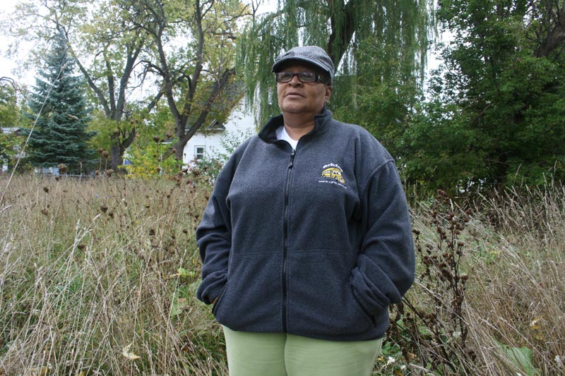 Saginaw homeowner Madeleine O'Neal, standing in a weedy lot near her home, said she believes the city has abandoned her neighborhood. (Bridge photo by Ted Roelofs)