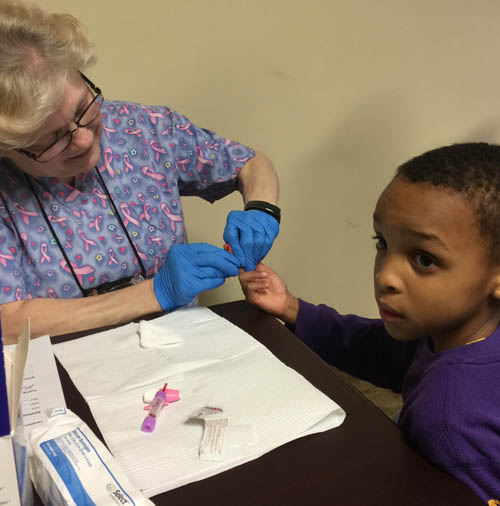JaMise Wash-Lang of Flint, took her son JaCarie, 5, to get a blood test last week. (Bridge photo by Chastity Pratt Dawsey) 