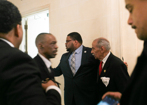 Rev. Charles Williams II, center left, ushers U.S. Rep. John Conyers through the crowd at the National Action Network Michigan Chapter's Dream Keepers Brunch and Award Ceremony in January at the Detroit Athletic Club, one of many venues in the city that were not welcoming to blacks in 1967. (Bridge photo by Brian Widdis)