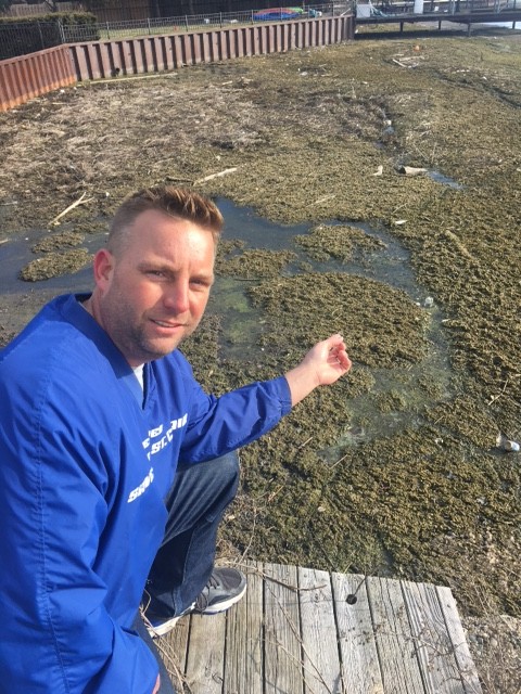 Mike Gutow learned some hard truths about the deterioration of Michigan’s water supply when he bought a home on Lake St. Clair. He shows off some lake muck in Harrison Township near Metro Beach. (Courtesy photo) 