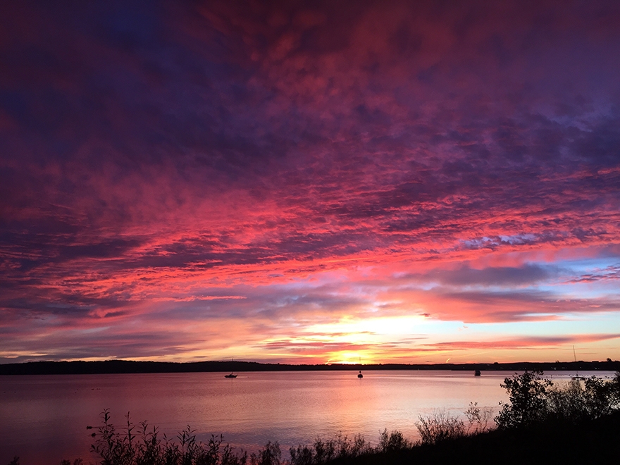 A Pure Michigan moment: the sun rising over Traverse City’s West Grand Traverse Bay. (Photo by Alison Goss of Travel Michigan) 