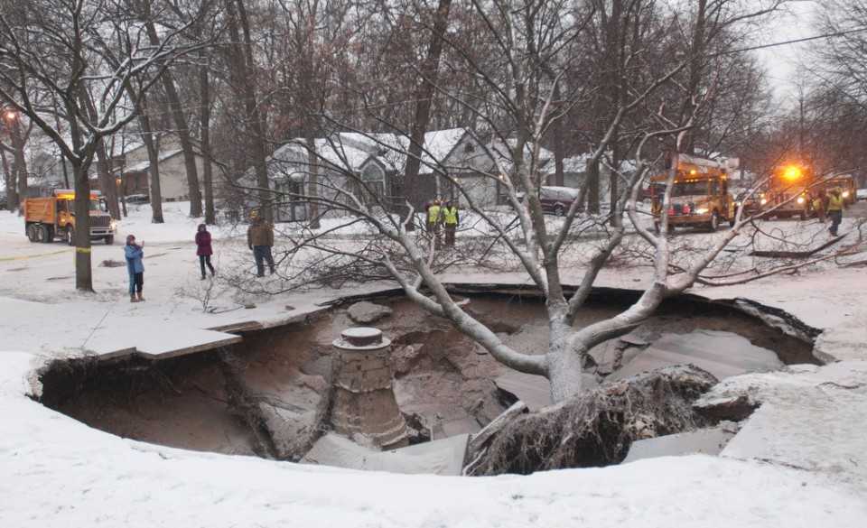  In 2013, a water main break left a massive sinkhole on the city's southeast side. (Photo by Chris Clark of MLive.com/The Grand Rapids Press) 
