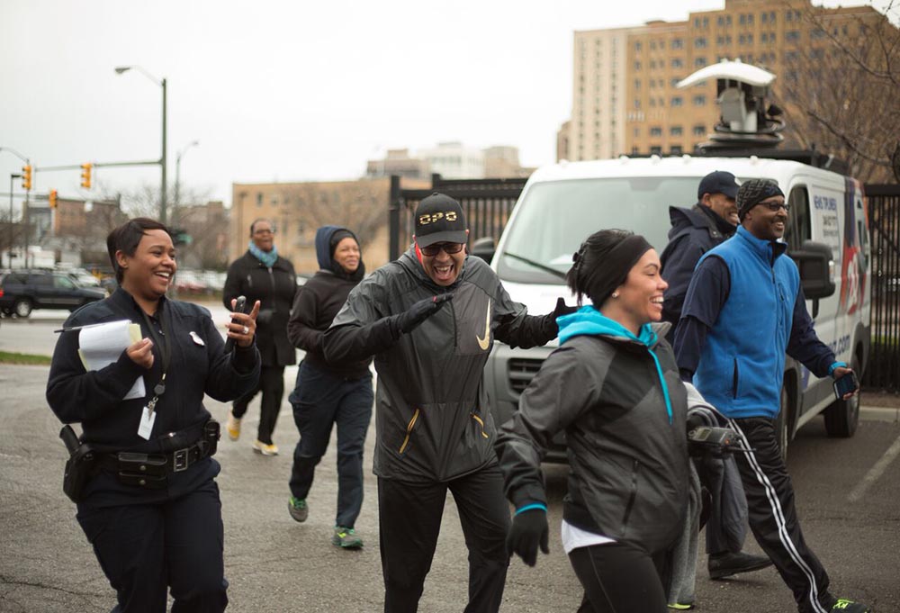 Detroit Police Chief James Craig laughs as he finishes the department’s National Walking Day fitness event. The police union chief says Craig has lifted morale among officers by listening to the concerns of rank-and-file cops. (Bridge photo by Brian Widdis)