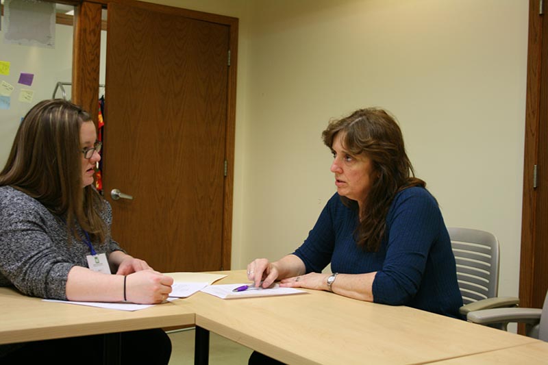 Laurie Brace, right, plots job-hunting strategy with volunteer mentor Holly Monahan at the Women's Resource Center in Grand Rapids. (Photo by Ted Roelofs)