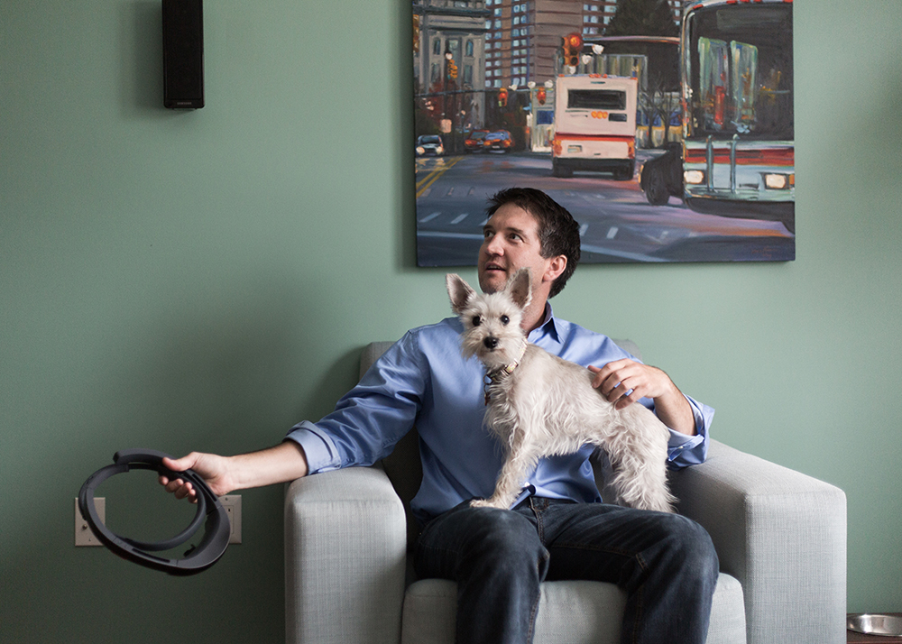 Kevin Morin in his Book Cadillac condo with his dog. (Photo by Brian Widdis)