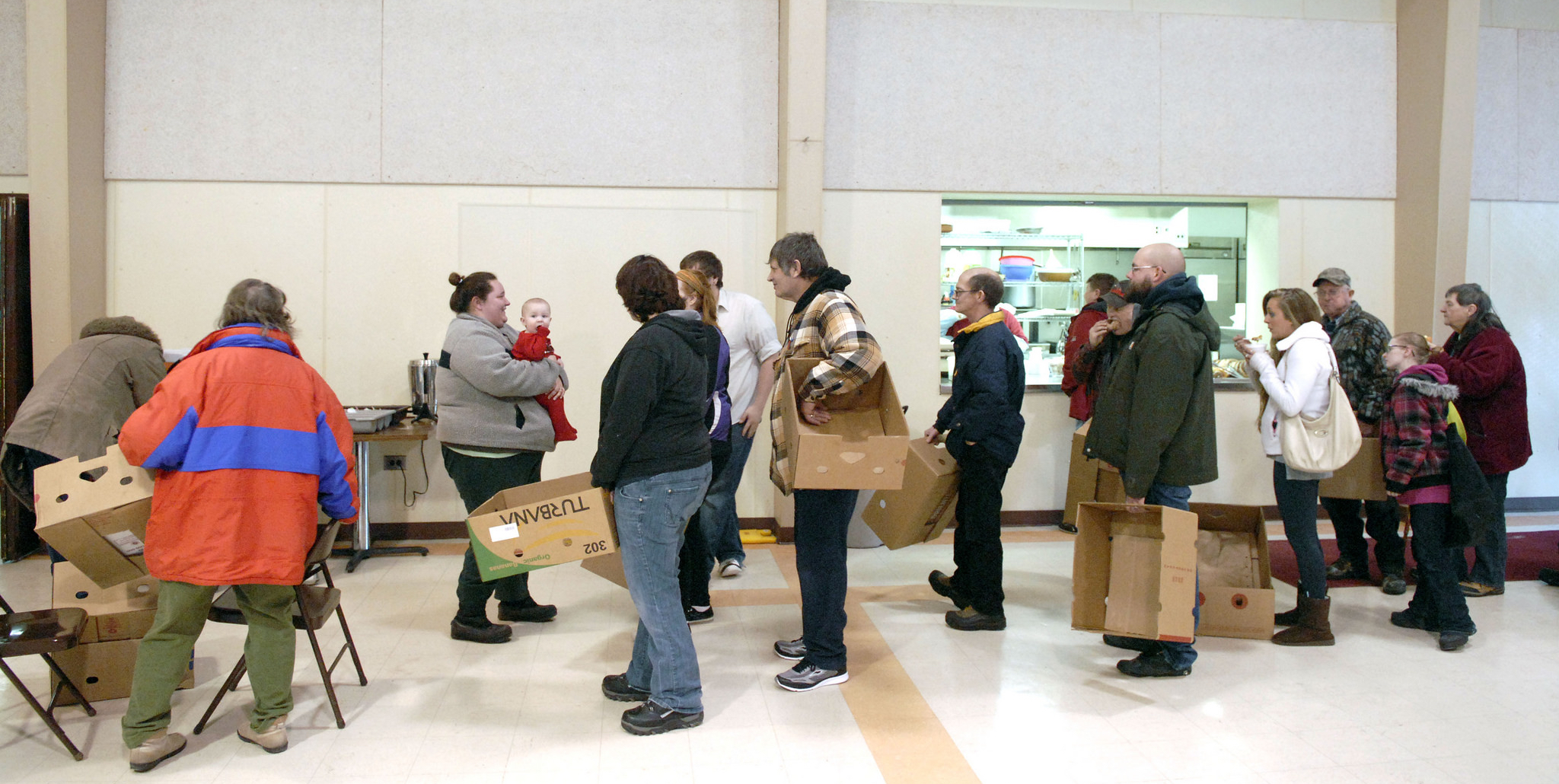 A line forms at a church food bank in Alanson, Mich. Such third-party aid to the poor has been counted as "welfare spending" by the state to qualify for federal block grants to relieve poverty. (Bridge photo by John Russell)