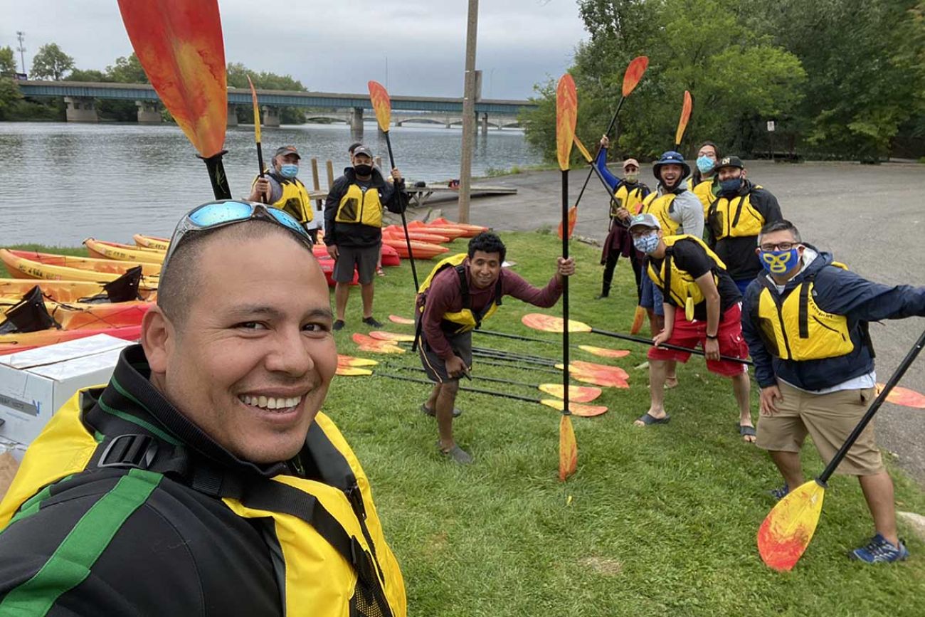 Members of the Grand Rapids chapter of Latino Outdoors pose for a photo during a group paddling trip.