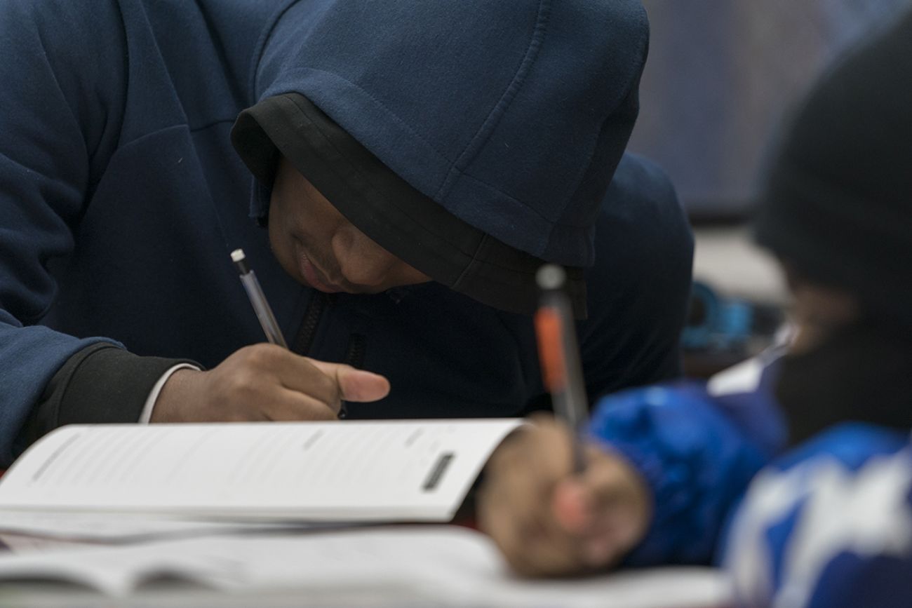 teens working on a workbook