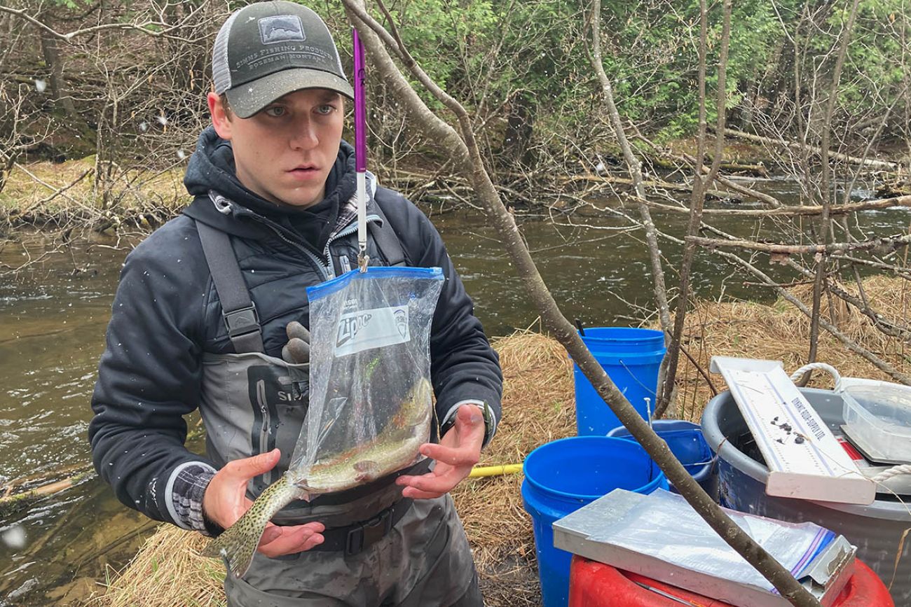 man holding fish in bag