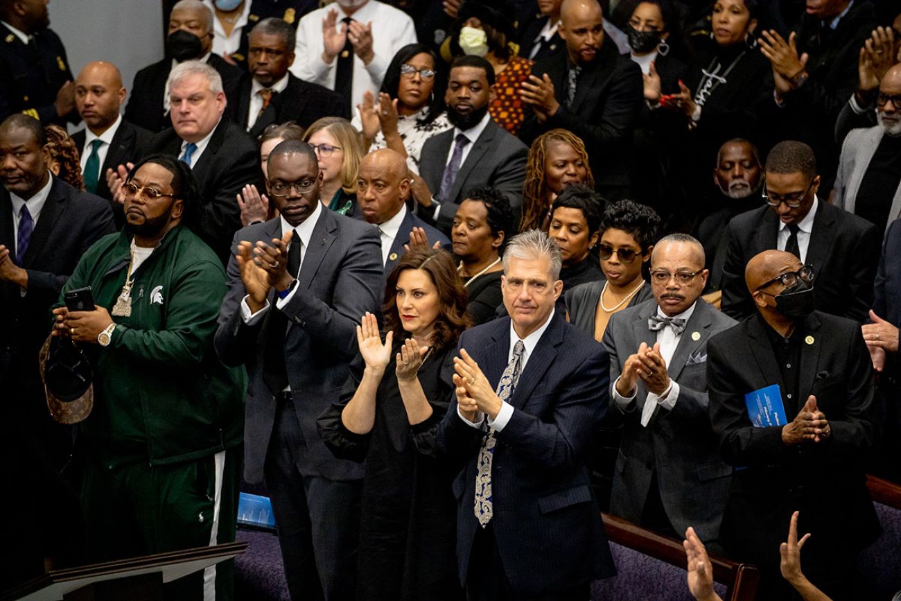 a crowd of people clapping