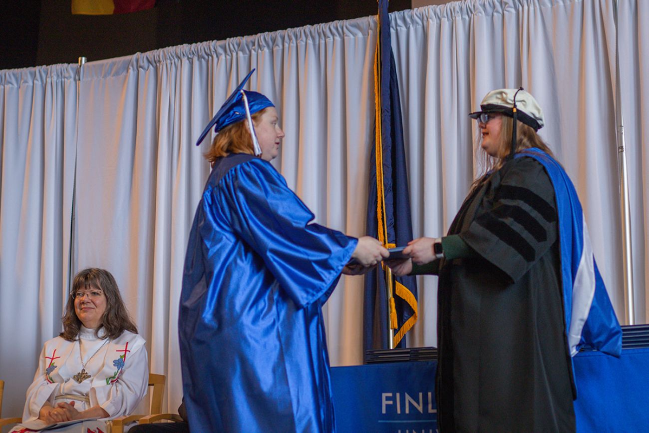 a student getting diploma on stage