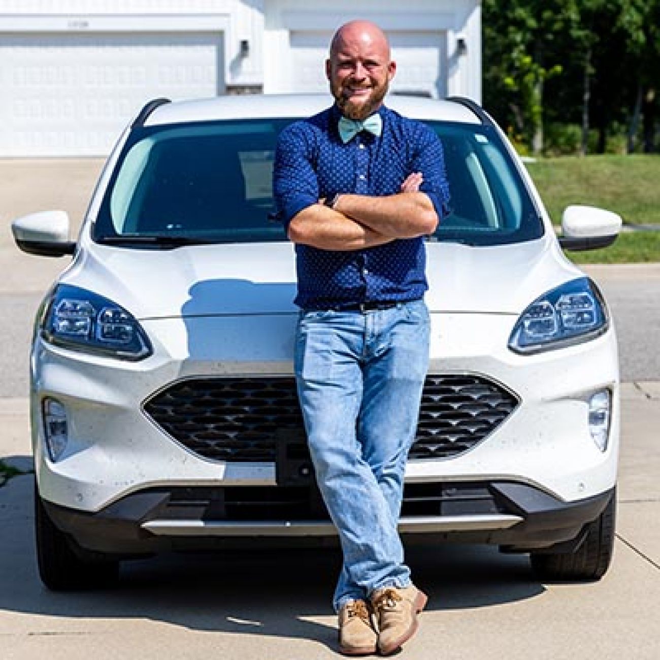 Walker resident Rob Conat standing in front of his car