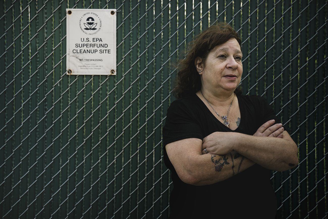 Carol Garza in front of sign