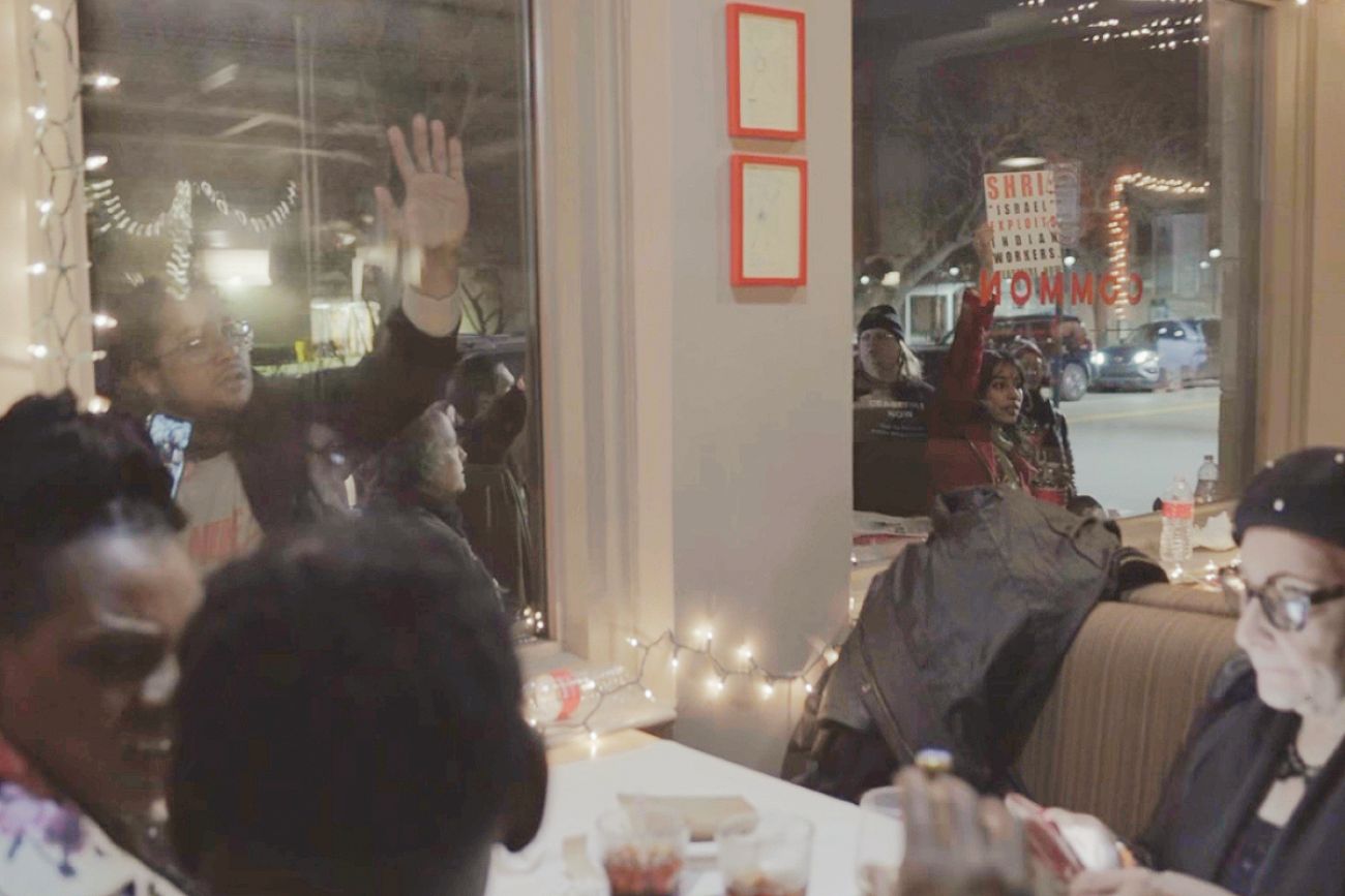 Protestors stand outside restaurant