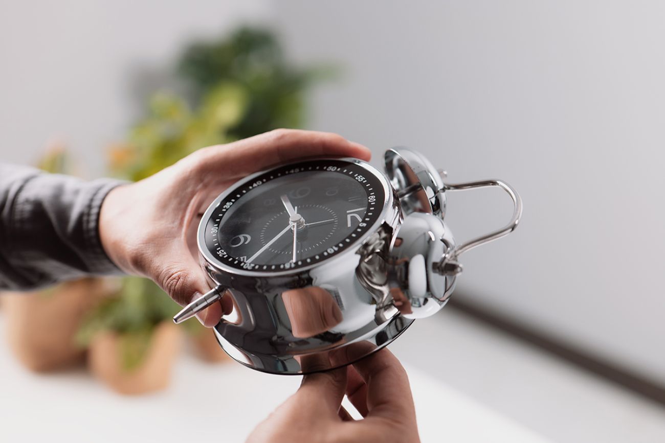 Spring forward, set your clocks ahead one hour. Alarm with hand