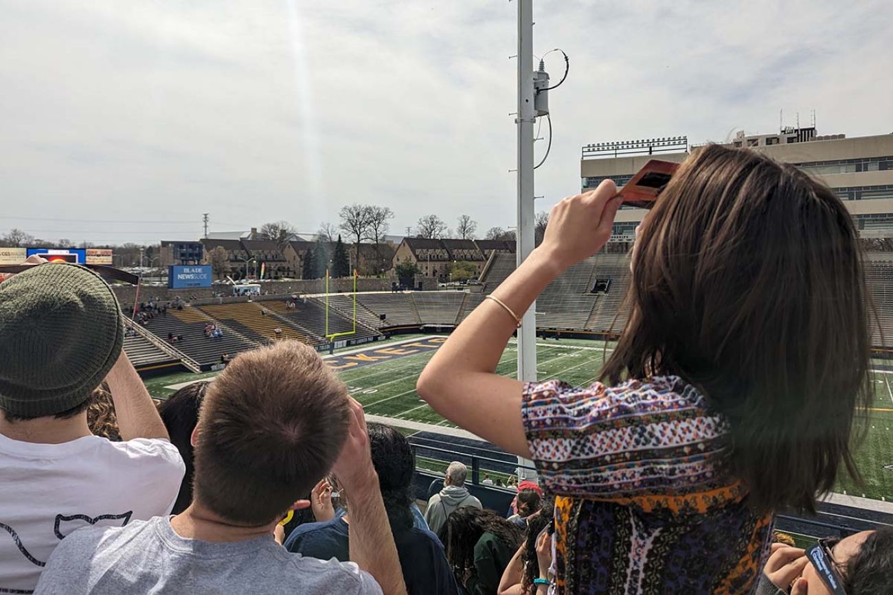 woman taking picture at the sky