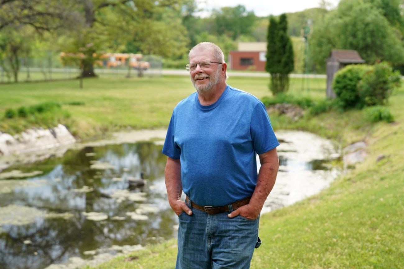 Bill Gurn wearing a blue shirt. He is posing for a picture outside