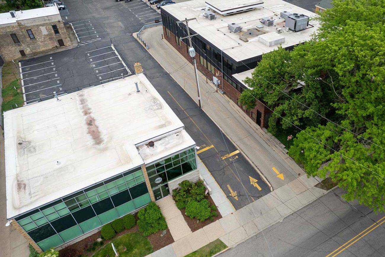 a parking lot with two buildings on each side