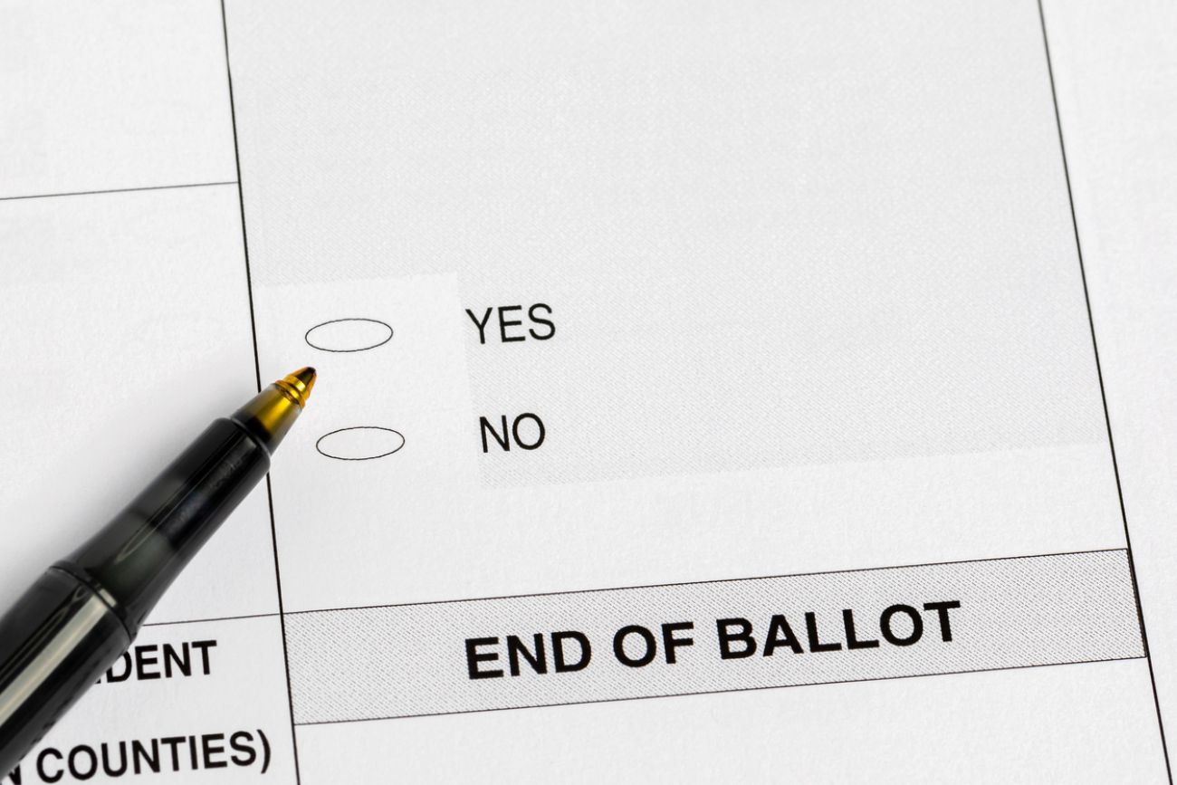 Election ballot with yes or no question and pen