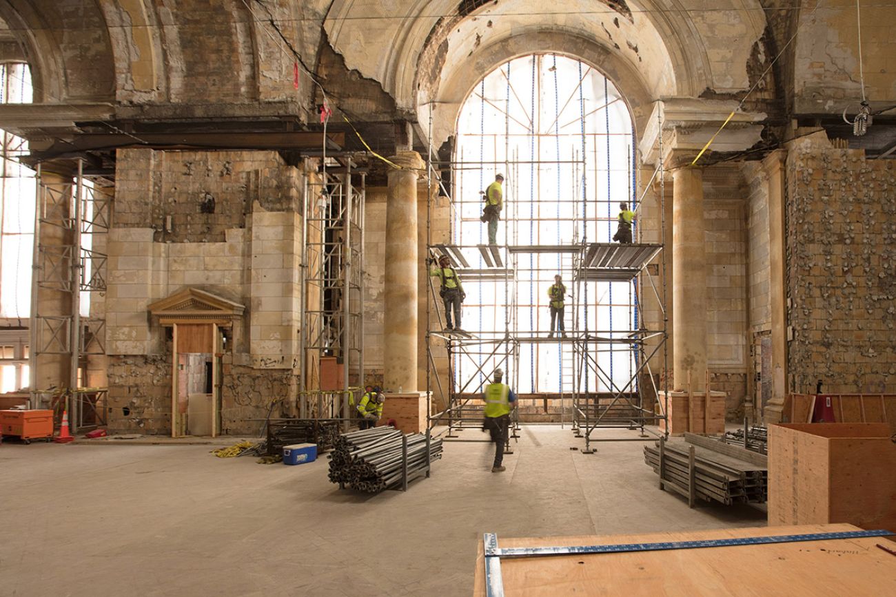 construction workers working inside the station