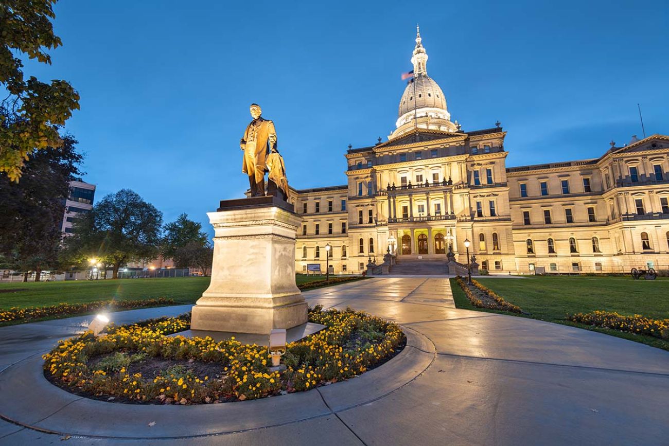 Michigan State Capitol during the evening. In front is a statue of former Governor Austin Blair 