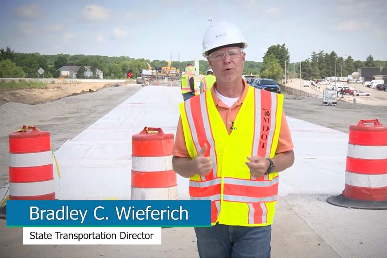 Michigan Department of Transportation Director Bradley Wieferich in a hard hat walking on the road