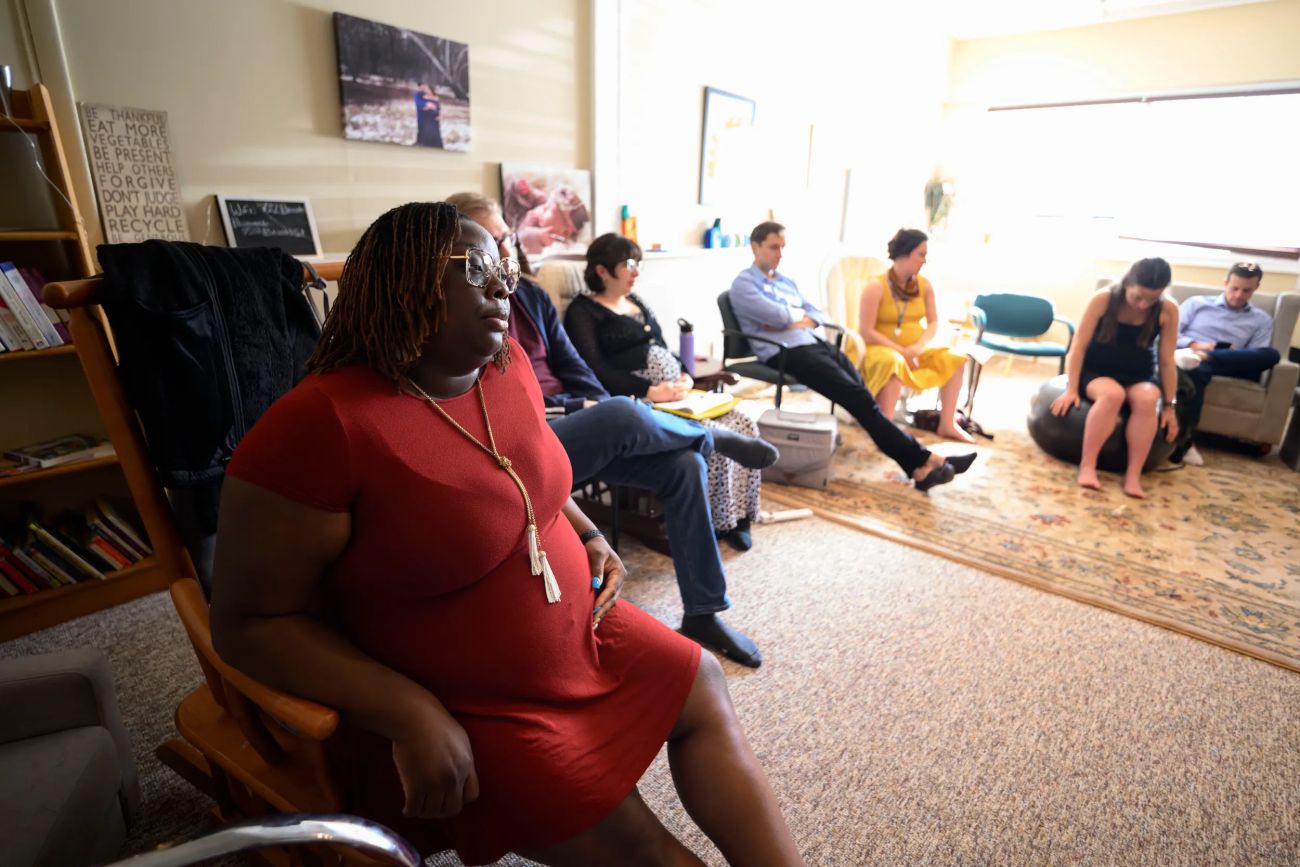 Asia LoveLady is sitting in a red dress. Others are in the room