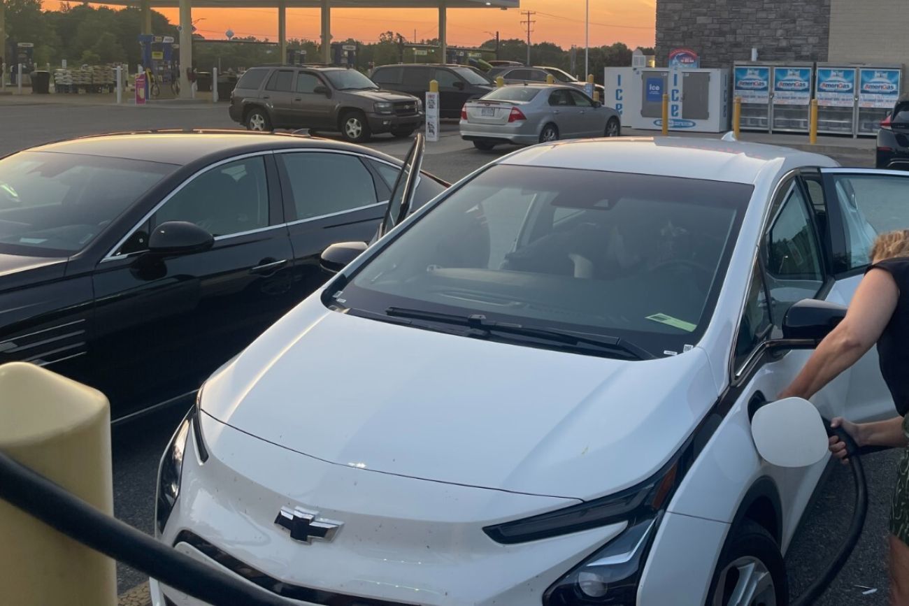 White Chevy Bolt being recharged at a Meijer gas station.